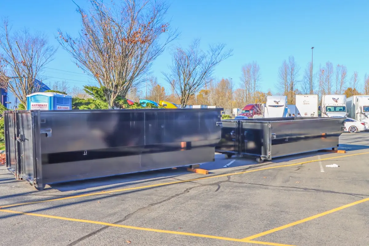 Professional dumpster rental service with roll-off container on residential driveway in Candlewick Lake
